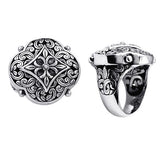 Handcrafted sterling silver Balinese statement ring with ornate floral medallion, detailed scrollwork, and oxidized finish for a bold artisan look.